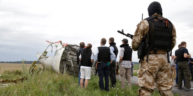 Representatives from the Organisation for Security and Cooperation and Ukrainian experts arrive at the crash site. Photo / AP