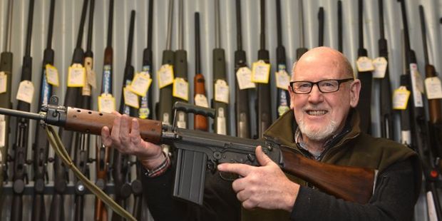 Centrefire McCarthy managing director Selwyn Shanks, holding a FN FAL L1A1 military-style semi-automatic, says cheaper weapons have helped boost firearms sales. Photo / Peter McIntosh