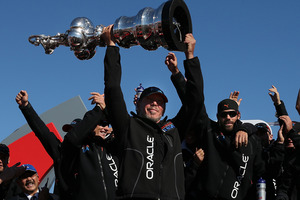 Oracle boss Larry Ellison holds aloft the America's Cup. Photo / Getty Images