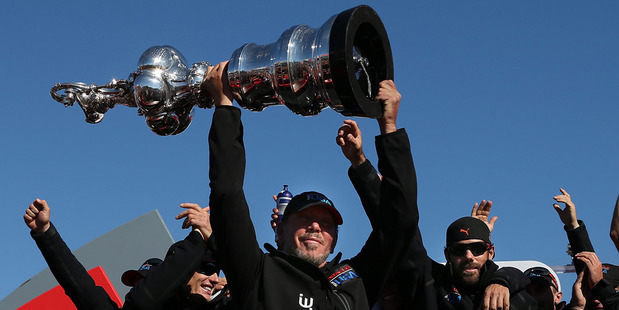 Oracle boss Larry Ellison holds aloft the America's Cup. Photo / Getty Images