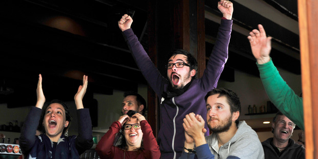 Germany fan Bob Beynis leaps for joy as his team scores a goal against Argentina as friends (from left to right) Justina Allauche, Agatha Latissier and Jememy Pinto watch on. Photo/George Novak