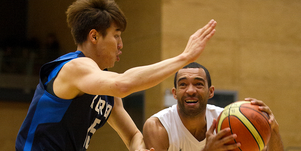 New Zealands, Everard Bartlett, tries to keep the ball from South Korea player, Jong Kyu Kim, during the basketball test match between the New Zealand Tall Blacks and South Korea played at the ASB Are