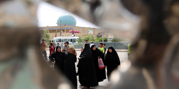 Iraqi women gather the morning after a car bomb explosion in Baghdad's eastern Ur neighborhood, Iraq. Photo / AP