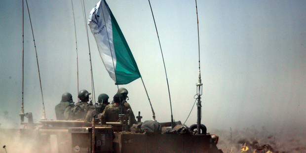 Israeli soldiers on an armored personnel carrier move to a new position on the Israel-Gaza Border. Photo / AP