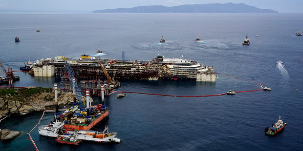 Operations to refloat and tow away the luxury cruise ship Costa Concordia get underway on the tiny Tuscan island of Giglio, Italy. Photo / AP