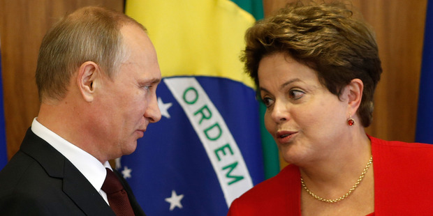 Russia's President Vladimir Putin, left, and Brazil's President Dilma Rousseff (right) with the three other BRICS nations will this week unveil a $100 billion fund to fight financial crises. Photo / AP