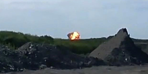 A fireball is seen shortly after a Malaysia Airlines passenger plane carrying 295 people was shot down. Photo / AP