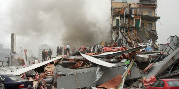 Police and volunteers work to rescue people trapped in the collapsed CTV building. Photo / Geoff Sloan