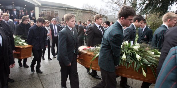 The coffins of Sam and Angus Donald are carried from the Rathkeale College auditorium. Parents Tracie and David Donald are at centre and brother Bayley Donald was a pall bearer. PHOTO/LYNDA FERINGA