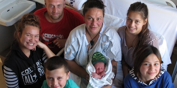 Diana Thomson with her impatient baby boy, here just 6-hours-old, and (clockwise from front) son Isaiah Stillwell, 7, niece Aaliyah Thomson, 18, partner Anthony Stillwell, and daughters Aiysha Thomson, 15, and Jazzmin Thomson, 11. Photo/Peter de Graaf