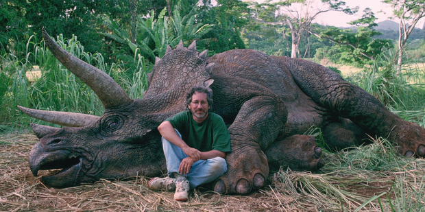 Steven Spielberg poses with a 'dead' Triceratops.