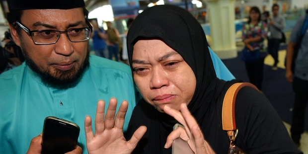 Relatives of passengers who were on Malaysian Airlines Flight 17 gather at Kuala Lumpur International Airport. Photo / AP