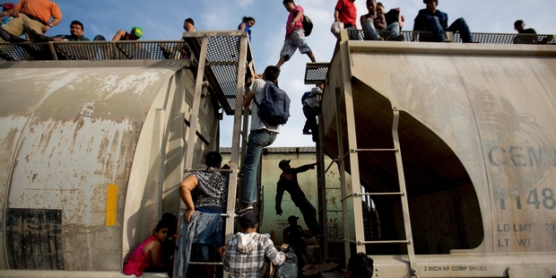 Central American migrants climb on a train heading towards the United States border with Mexico. Photo / AP