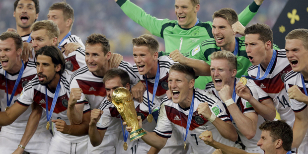 German players celebrate with the World Cup trophy following a 1-0 win over Argentina. Photo / AP