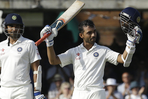 Ajinkya Rahane, right, celebrates scoring a century alongside batting partner Mohammed Shami. Photo / AP