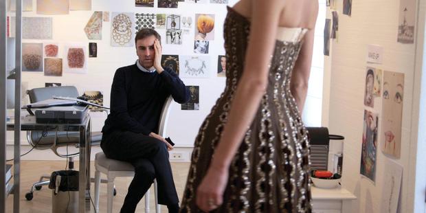Raf Simons inspects a dress from the Dior archives. Picture / Supplied