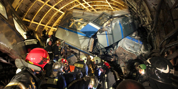 Rescuers work in a tunnel after the Moscow train derailment. Photo / AP