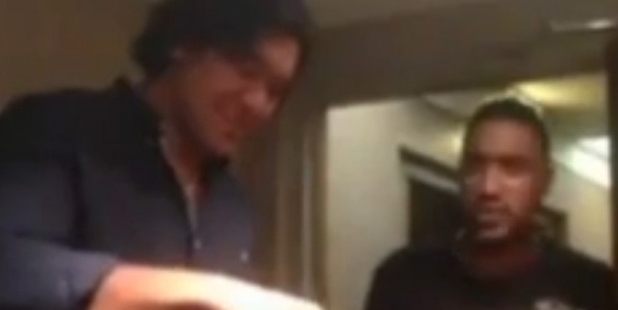 Steven Luatua pours beer down the throat of Josh Stol in a video seen on YouTube.