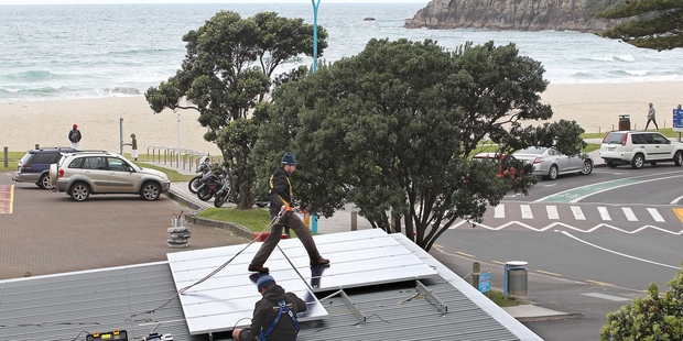 PowerSmart install solar panels at Mt Maunganui campground last year. Photo / APN