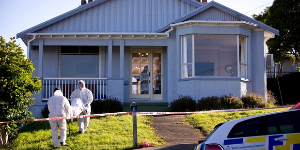 The body of one of the two child victims is carried from the house in which they were killed by their father, Edward Livingstone. Photo / Dean Purcell