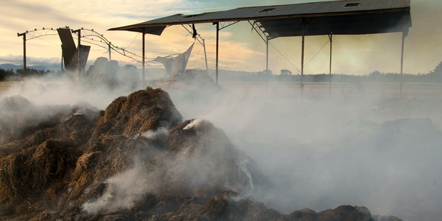 The farm shed full of hay, still smoking, in Central Hawke's Bay yesterday evening. Fire authorities decided it was beyond saving. Photo/Warren Buckland