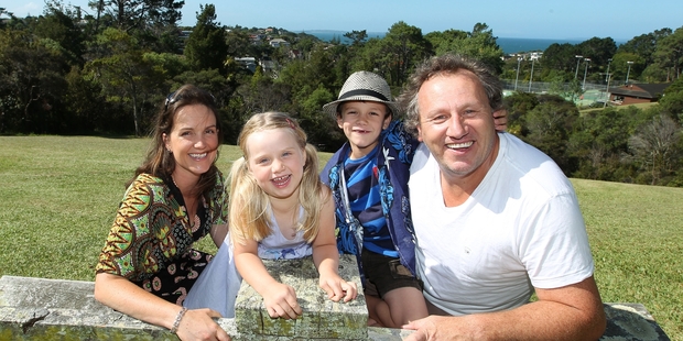 Andrew Grainger and wife Sacha Hickman, daughter Ava Hickman, 4, and son Max Hickman, 7, enjoy family fun at Centennial Park in Campbells Bay. Photo / Getty Images