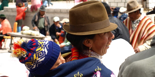 A mother carries her sleeping baby in a shawl on her back. Photo / Pamela Wade