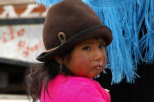 A child waits patiently amid the hustle and bustle of market day. Photo / Pamela Wade