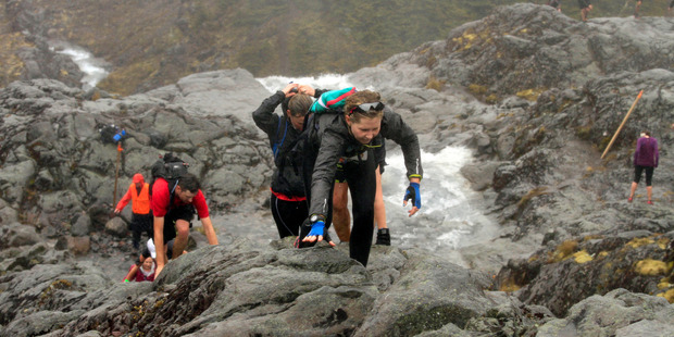Rachel Grunwell is reduced to all fours as she clambers up the side of the rockface. Photo / Supersport Images