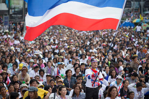 An anti-government protestor waves a flag during a rally outside MBK Center in Bangkok. Photo / AP