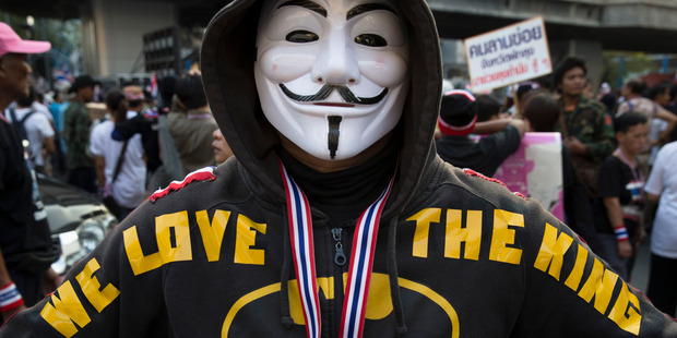 An anti-government protestor displays his hoodie saying 'We love the King' in Bangkok. Photo / AP