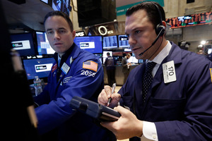 Specialist Jason Hardzewicz, left, and trader Michael Zicchinolfi work on the floor of the New York Stock Exchange. File photo / AP