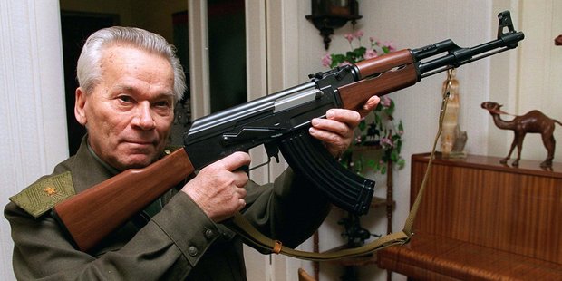 Mikhail Kalashnikov shows a model of his world-famous AK-47 assault rifle at home. Photo / AP