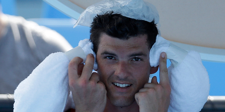 Frank Dancevic of Canada applies an ice pack to his head after collapsing during his first round match against Benoit Paire of France as temperatures topped at 43 C (108 F). Photo / AP