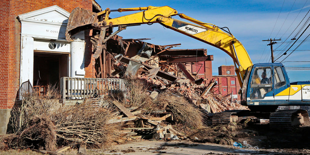 Demolition begins at the entrance to the former headquarters of the Berkshire Hathaway mill, where investor Warren Buffett first made his mark. Photo / AP