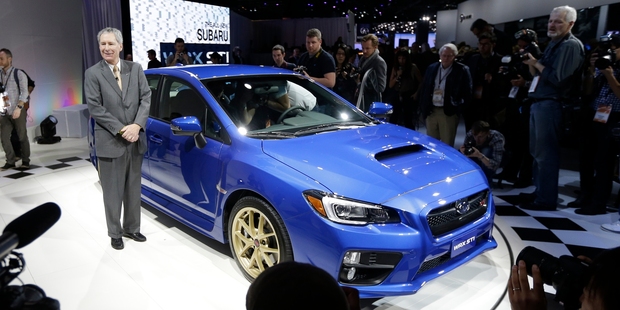 Tom Doll, president and COO of Subaru of America stands next to the new WRX STI at the North American International Auto Show in Detroit. Photo / AP