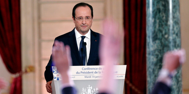 Reporters raise their hands during French President Francois Hollande's annual news conference. Photo / AP