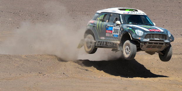 The Mini driven by Stephane Peterhansel and co-pilot Jean Paul Cottret, both of France, jump a dune during the tenth stage of the Dakar Rally. Photo / AP