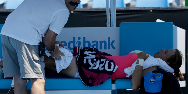 Varvara Lepchenko of the U.S. receives treatment for heat related illness during her second round match against Simona Halep of Romania. Photo / AP