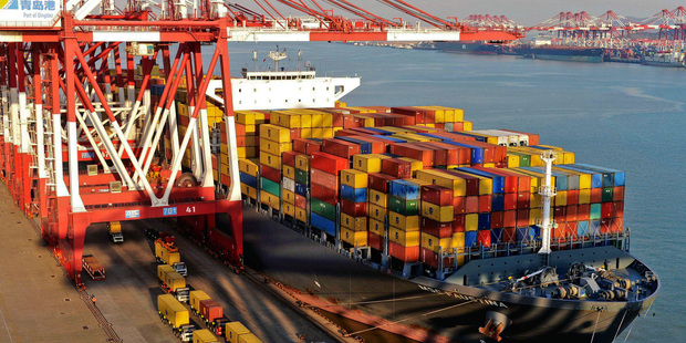 Trucks carry containers that were unloaded from a ship at a port in Qingdao, in eastern China's Shandong province. Photo / AP