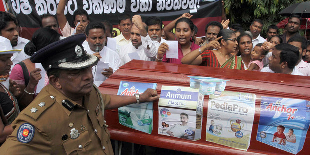 Protestors outside a Fonterra plant in Colombo, Sri Lanka last year after the August botulism contamination scare. The world is now paying closer attention to Fonterra. AP Photo/Sanka Gayashan