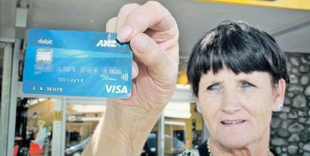 TIMELY REMINDER: Cherie Scott's mother, Carol Johnson, holds an ANZ debit card which someone stole and used to take $170 from an ASB Bank ATMon Middle Road. Footage was wiped after 28 days and police did not catch the offender, highlighting a need for vigilance when using money machines.