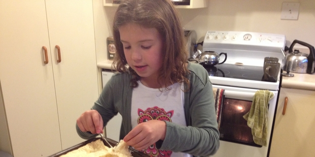 Lucy cutting her bacon and egg pie.