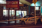 Scene of crime officers cordoned off the Ezy Cash store last night. Photo / Chris Loufte Scene of crime officers cordoned off the Ezy Cash store last night. Photo / Chris Loufte