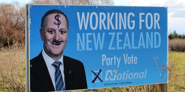 A billboard featuring Prime Minister John Key, put up by Tukituki MP Craig Foss on Karamu Rd North, is among the latest to suffer a vandalism attack. Photo / Duncan Brown