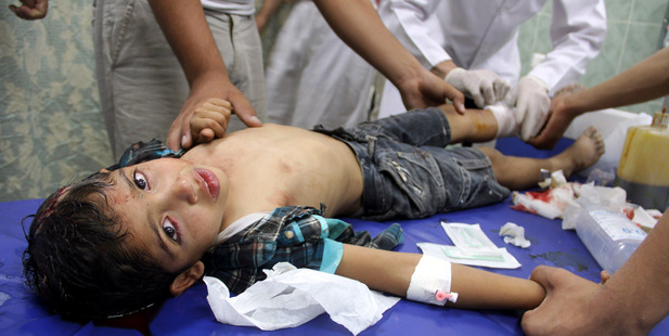 Palestinian medics treat a wounded boy following an Israeli air strike on a family house, at a treatment room of al Najar hospital in Rafah, in the southern Gaza Strip. Photo / AP