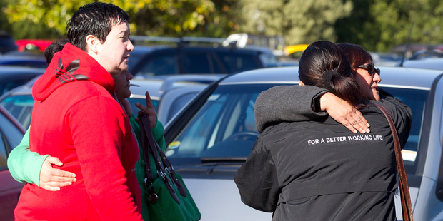 Fonterra staff comfort each other after a meeting that announced up to 110 jobs could go after Fonterra confirms restructuring at its Canpac plant. Photo / Christine Cornege