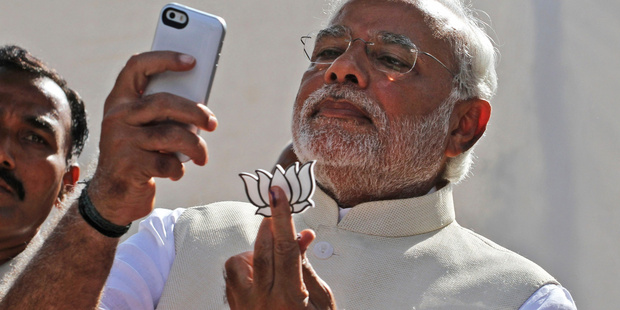 India's Prime Minister Narendra Modi using his mobile phone. Chinese company Xiaomi is targeting India to boost its smartphone sales. Photo / AP