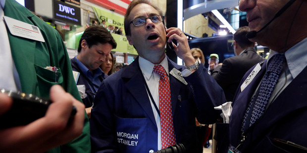 Trader Dudley Devine, center, works on the floor of the New York Stock Exchange. File photo / AP