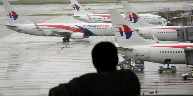 A visitor looks out on the tarmac at the Kuala Lumpur International Airport (KLIA). Photo / AP
